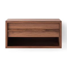 a wooden shelf with two open compartments on the top and one closed drawer at the bottom