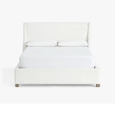 a bed with white sheets and pillows on top of it's headboard, in front of a white background