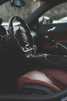 the interior of a car with steering wheel and dashboard