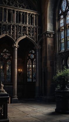 the interior of an old gothic church with stained glass windows and stone flooring on both sides