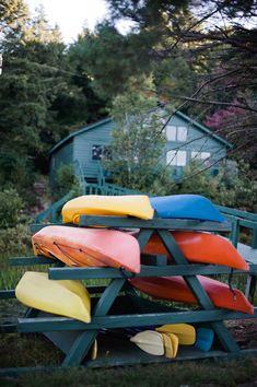 several kayaks are stacked on top of each other