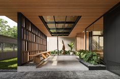 an outdoor area with benches and plants on the side of it, surrounded by wood paneling