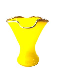 a yellow vase sitting on top of a white table