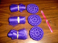 purple crocheted bows and pins laid out on a table