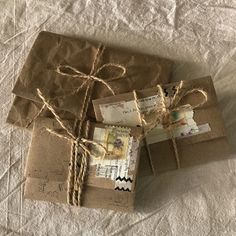 three packages tied with twine on top of a bed