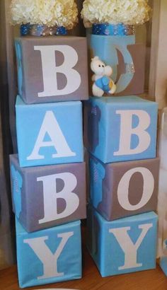 baby blocks with teddy bears and flowers in them are stacked on top of each other