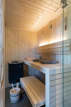 the inside of a sauna with wooden walls and benches