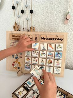 a person is playing with some sort of magnets on a board that says, my happy day