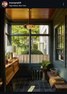 the sun shines in through an open window into a room with blue walls and tile flooring