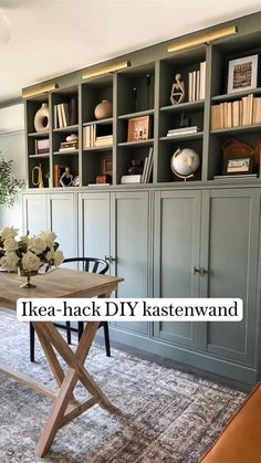 a living room with bookshelves and a table in front of the bookcases