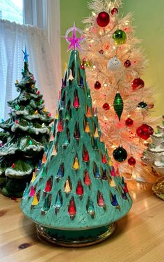 a small christmas tree sitting on top of a wooden table