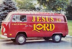 an old red van with the word jesus is lord painted on it