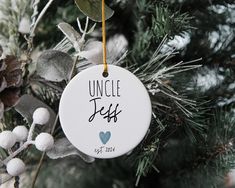 an ornament hanging from a christmas tree with the words uncle jeff on it