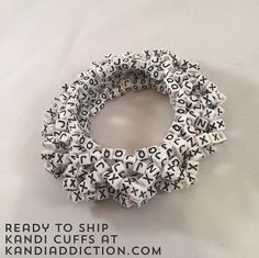 a bracelet made out of letters on a white background with the words ready to ship kandi cuffs at kandiadicton com