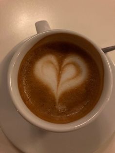 a cup of coffee with a heart drawn on it