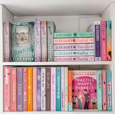 a white book shelf filled with lots of different types of books on top of each other