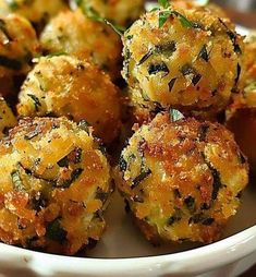 a white bowl filled with fried food on top of a table