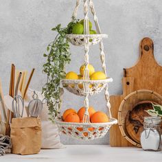 three tiered fruit basket with oranges and lemons