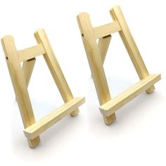 two miniature wooden easels sitting side by side