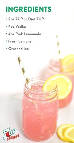 two mason jars filled with pink lemonade and topped with straws, garnished with lime