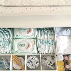 an organized drawer filled with diapers, wipes and other items for baby care