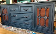 an old dresser is painted blue and has ornate carvings on the doors, drawers, and sides