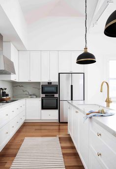 the kitchen is clean and ready for us to use it's white cabinetry