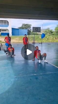 a group of young men standing on top of a basketball court