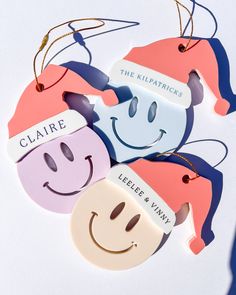 three personalized christmas ornament hanging from strings with faces on them and the name claire