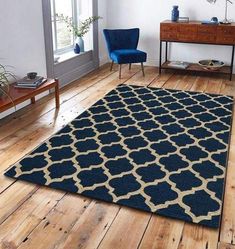 a living room with wooden floors and a blue rug