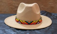 100 % Leather Hat-band is Hand Beaded with intricate beaded patterns by skilled Artisans Inspired by Native American crafting techniques and Indian beaded jewelry Beaded portion about 19.0 inches, handmade products, dimensions may slightly vary. Adjustable ties in the back. Hypoallergenic - Made with non-reactive Materials 100 percent Natural Environment friendly materials. Handcrafted with tiny Cubic Zirconia Seed Beads with beautiful and detailed beadwork. Traditional Multicolor Beaded Hat Band, Festival Multicolor Beaded Hats, Handmade Southwestern Multicolor Hats, Handmade Multicolor Southwestern Hats, Handmade Southwestern Multicolor Hat Band, Multicolor Bohemian Hat With Bead Caps, Multicolor Beaded Bohemian Hat, Southwestern Beaded Hats For Festivals, Southwestern Beaded Festival Hat