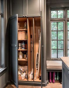 an open cabinet in a kitchen filled with cleaning supplies