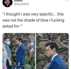 the man is wearing a blue suit and carrying a suitcase