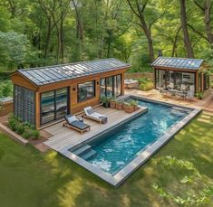 an aerial view of a pool house in the woods