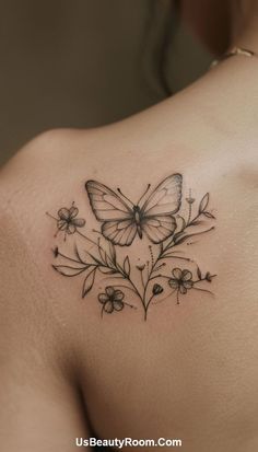 a woman with a butterfly tattoo on her upper back shoulder and arm, holding flowers in the foreground