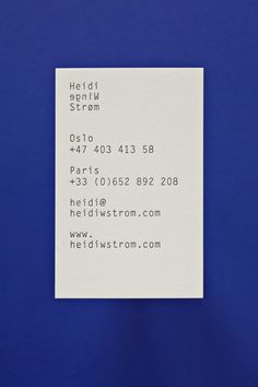 a close up of a piece of paper on a blue surface with the words held in front of it