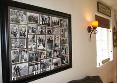 a black and white photo hanging on the wall next to a window in a living room