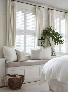 a bedroom with white walls and curtains on the window sill is featured in an instagram