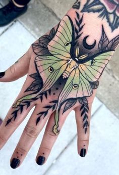 a woman's hand with a tattoo on it and a butterfly flying through the air