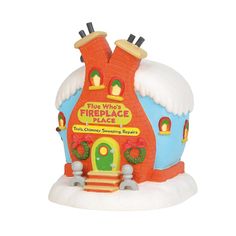 a toy fire place house with snow on the ground