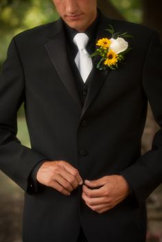 a man in a tuxedo with a flower on his lapel