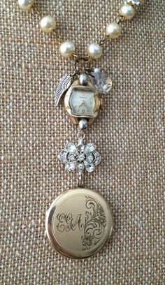 a necklace with a watch and pearls on it