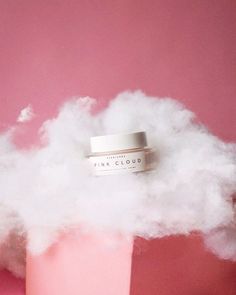 a pink container with some white clouds on it