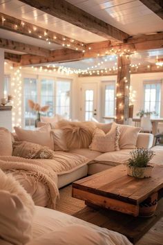 a living room filled with lots of furniture next to a fire place covered in lights