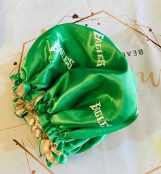 a green bag with the word beer on it sitting on top of a white table