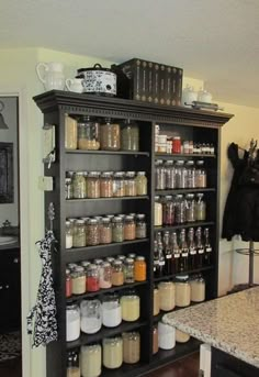 a kitchen filled with lots of different types of spices and condiments on shelves