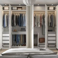 an open closet with clothes hanging on the walls and shoes in the bottom drawer, next to a bed