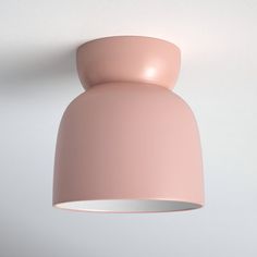 a pink light fixture hanging from the ceiling