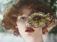 a woman with a butterfly on her face