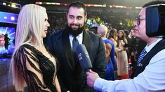 a man and woman talking to each other at an event